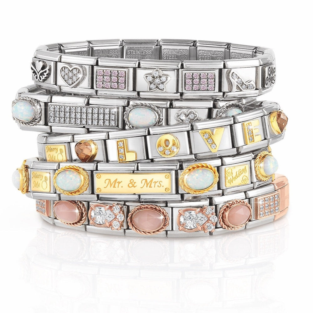 An image of multiple Nomination bracelets with a number of silver gold and rose gold charms