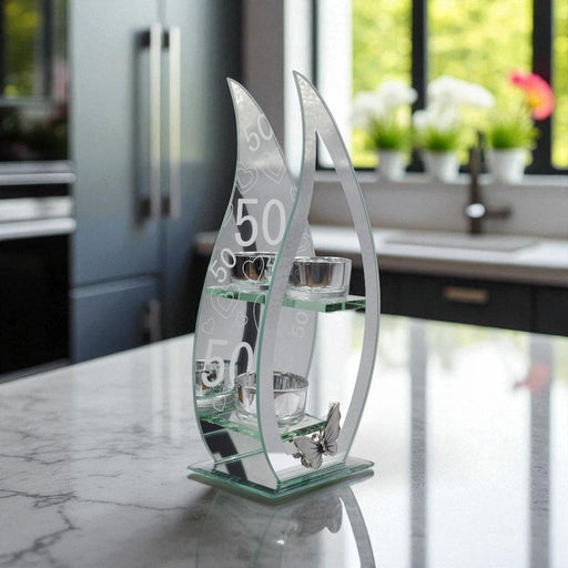 Decorative glass tealight holder with curved teardrop design and the numbers '50' on a mirrored background